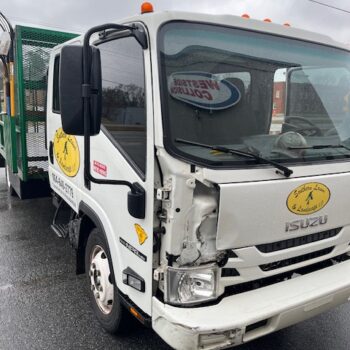 Damaged Isuzu truck front bumper